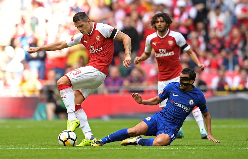 Chelsea's Pedro tackles Arsenal's Granit Xhaka. Tony O'Brien / Reuters