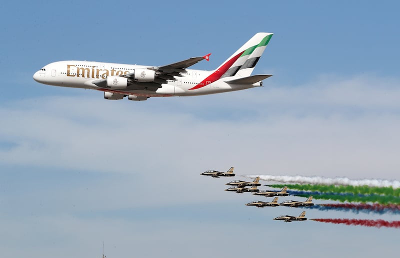 An Emirates plane and the Italian Air Force during a flying display at the Dubai Airshow. Pawan Singh / The National