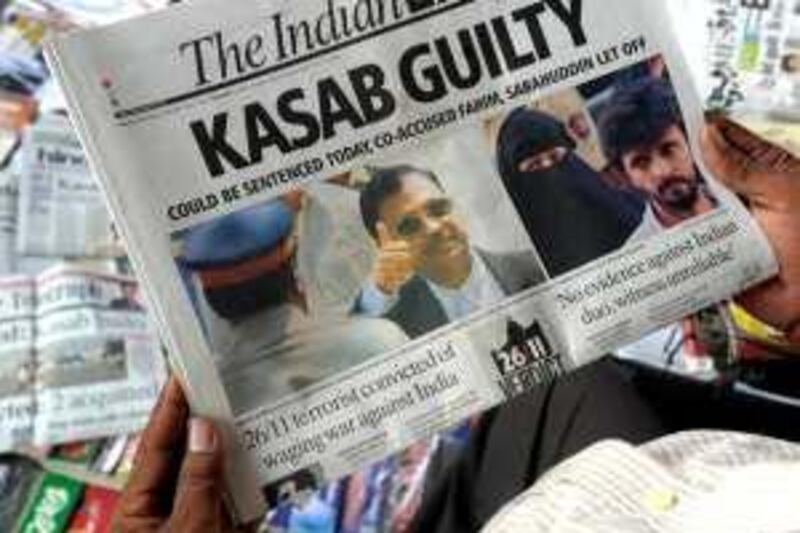 An Indian man reads a newspaper carrying a front-page story of convicted 2008 Mumbai attacks gunman Mohammed Ajmal Amir Kasab in Kolkata on May 4, 2010. An Indian judge weighed whether to send the lone surviving gunman from the 2008 Mumbai attacks to the gallows after his conviction for murder and waging war against India during the deadly siege. The prosecution is seeking the death penalty against Mohammed Ajmal Amir Kasab, a 22-year-old Pakistani, who was found guilty on May 3 after a year-long trial in a high-security prison. AFP PHOTO/Deshakalyan CHOWDHURY *** Local Caption ***  442275-01-08.jpg *** Local Caption ***  442275-01-08.jpg