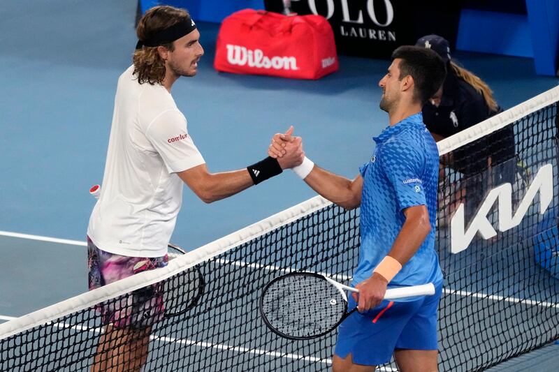 Novak Djokovic is congratulated by Stefanos Tsitsipas. AP 