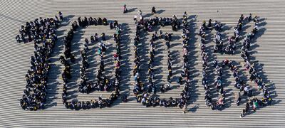 Pupils gather to form the 100K sign to celebrate 100,000 visits at Expo 2020 Dubai. Photo: Expo 2020 Dubai