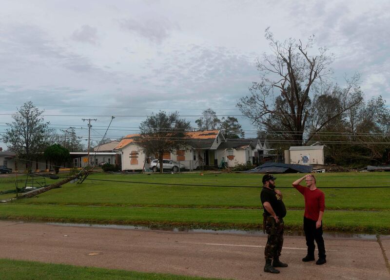 Two men react near a destroyed house after Hurricane Laura passed through in Lake Charles, Louisiana. AFP