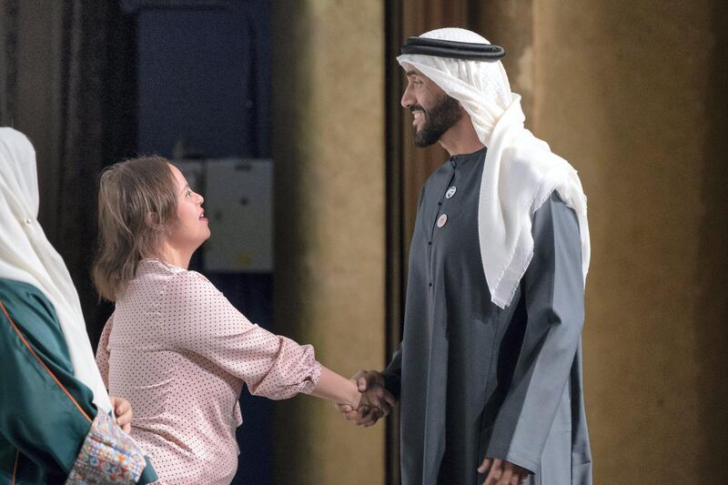 ABU DHABI, UNITED ARAB EMIRATES - March 13, 2019: HH Sheikh Nahyan Bin Zayed Al Nahyan, Chairman of the Board of Trustees of Zayed bin Sultan Al Nahyan Charitable and Humanitarian Foundation (R), greets Special Olympics athlete, Mariam Azzab (2nd L), after a lecture by Loretta Claiborne, Chief Inspiration Officer, Vice Chair of the Special Olympics International Board of Directors (not shown), titled "Changing the Game for Inclusion", at Emirates Palace. 
( Ryan Carter / Ministry of Presidential Affairs )?