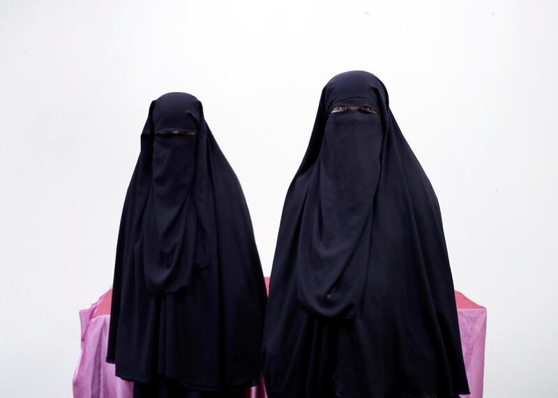 The mother, right, and wife of of a Yemeni detainee who has been held for months in Houthi prison, pose for a photograph.