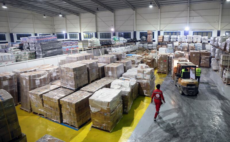 Red Crescent Society employees sort humanitarian aid bound for Palestinians in Gaza, at a warehouse in Arish, Egypt. EPA