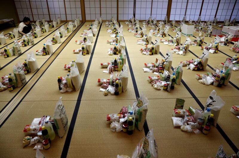 A Vietnamese volunteer prepares packages of food and protective masks for Vietnamese people in need and living in Japan, amid the coronavirus disease, at Nisshinkutsu temple in Tokyo, Japan. Reuters