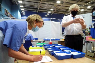 Britain's Prime Minister Boris Johnson visits a coronavirus disease (COVID-19) vaccination centre at Cwmbran Stadium in Cwmbran, South Wales, Britain February 17, 2021. Geoff Caddick/Pool via REUTERS