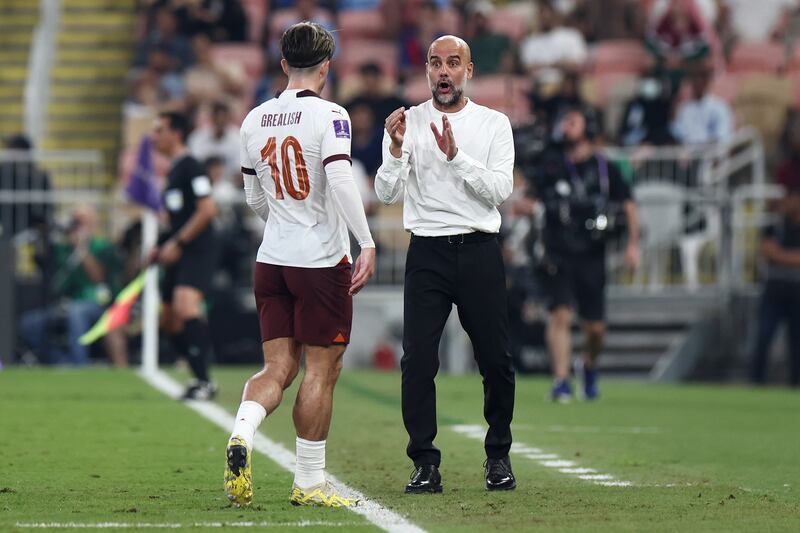 Manchester City manager Pep Guardiola talks to Jack Grealish. Getty Images