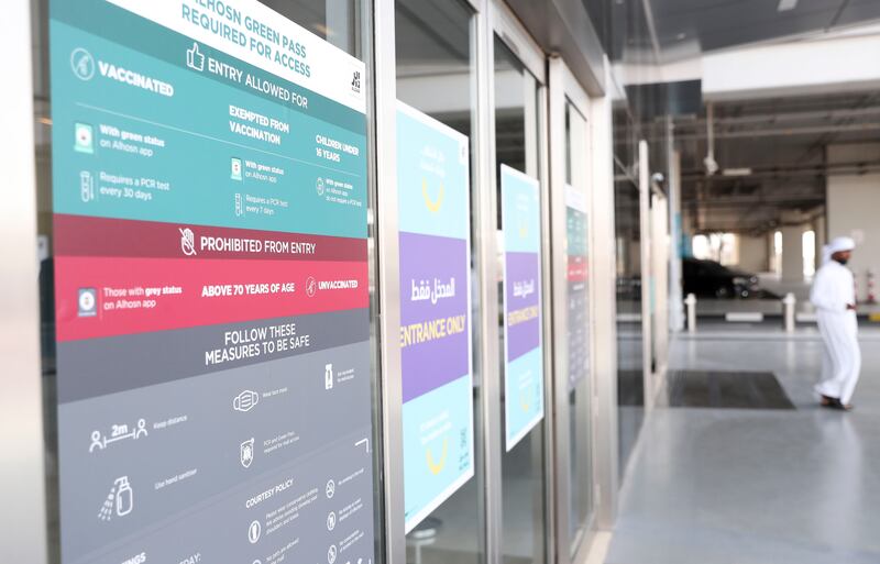 Signs at the entrance to Yas Mall in Abu Dhabi inform people to show proof of vaccination upon entry.