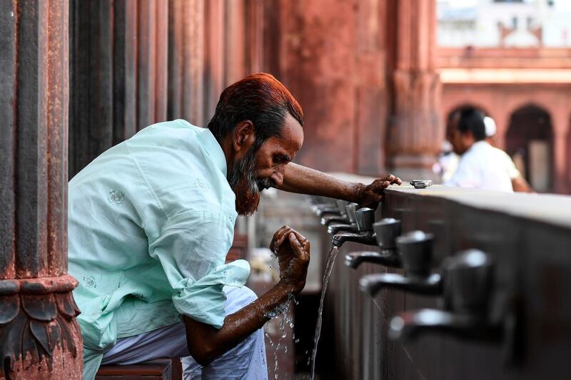 A man performs ablutions before praying at the Jamma Masjid. AFP