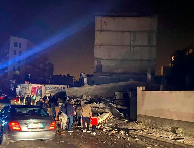 People look at a damaged building after an earthquake in Durres, western Albania. A magnitude-6.4 earthquake has shaken Albania. The United States Geological Survey said the earthquake was centered 30 kilometers (18.6 miles) northwest of the capital Tirana. It was at a depth of 10 kilometers (6.2 miles). AP Photo