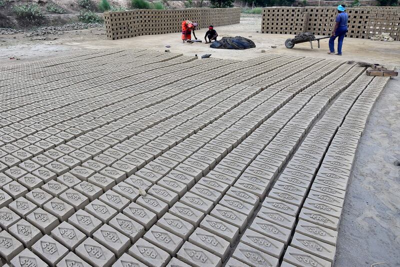 Labourers at work at a brick factory on the outskirts of Prayagraj in Uttar Pradesh, India. AFP