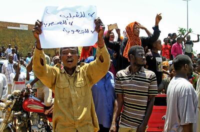 Hausa protesters in Khartoum hold up signs demanding "justice for the Blue Nile martyrs" and "no to the murder of Hausas". AFP