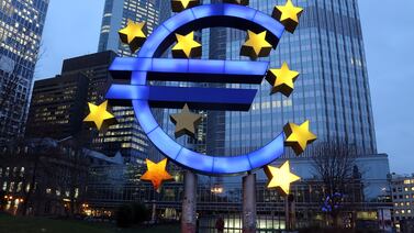 The symbol of the euro is illuminated in Frankfurt, Germany. The European Central Bank is being cautious as a widening interest rate differential with the US would weaken the currency. Getty Images