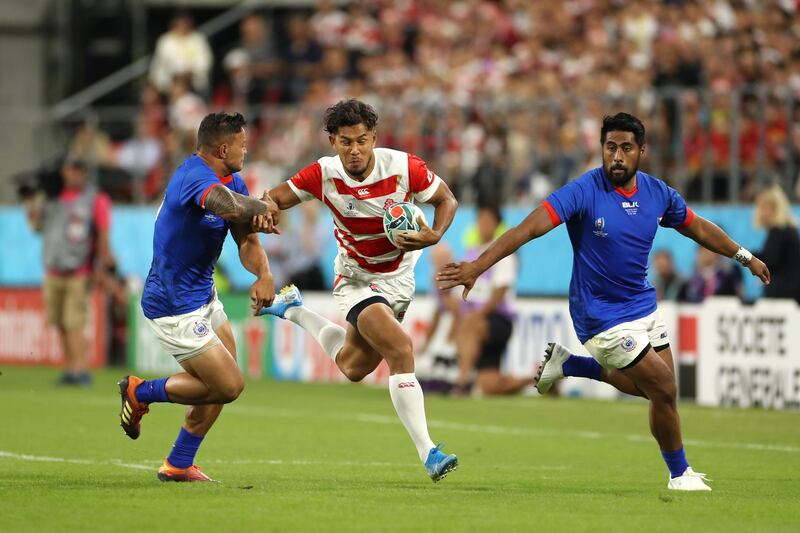 Ryohei Yamanaka of Japan holds off Alapati Leiua and Ah See Tuala at the City of Toyota Stadium. Getty