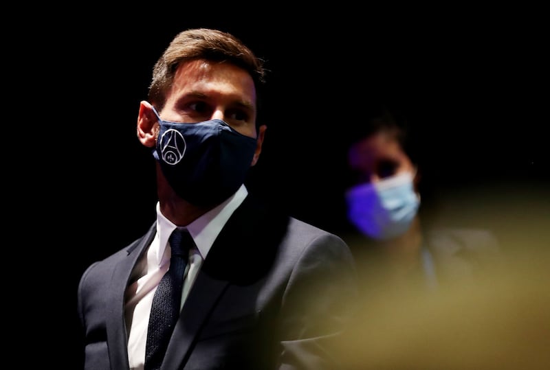 Lionel Messi arrives wearing a mask.
