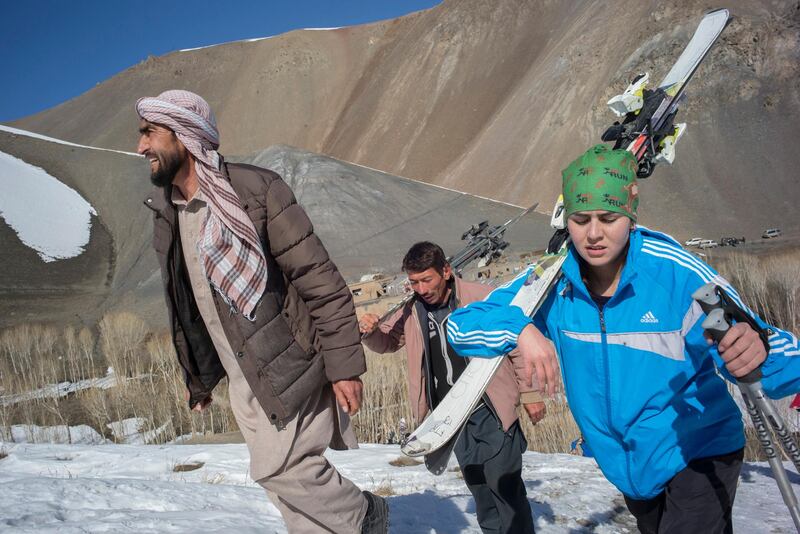 AFGHANISTAN, Bamiyan: 04 March 2021
Pictures from the annual Afghan Mountain Challenge - a ski event held in Bamiyan Province, 80 miles west of Kabul. Participants have to run up the mountain via specific checkpoints and then proceed to ski down. 
Pictured - Nazima and her father (left) make their way up to the challenge. Rick Findler for The National