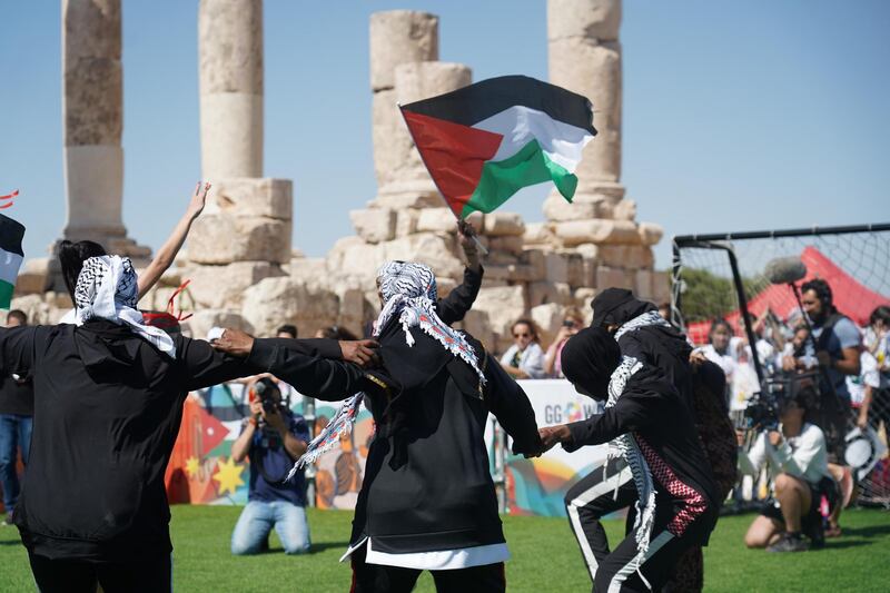 Football players from Gaza camp dance Dabke on the field before their match. Amy McConaghy / The National