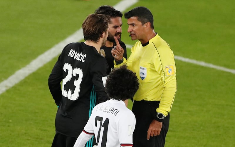 Referee Sandro Ricci talks with Real Madrid’s Mateo Kovacic and Isco. Amr Abdallah Dalsh / Reuters