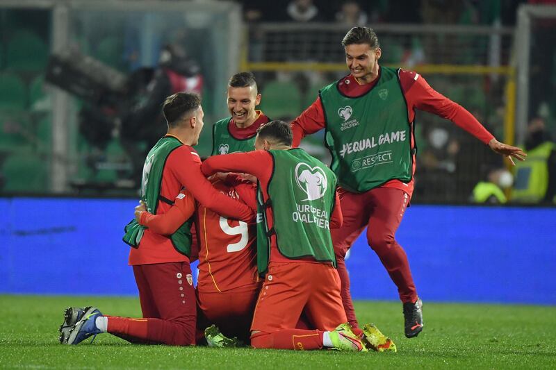 North Macedonia forward Aleksandar Trajkovski celebrates with teammates after scoring the winning goal. EPA