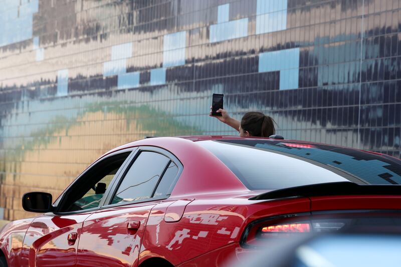 Motorists take pictures of various cars lined up during the No Filter DXB Supercar Parade. Photos: Khushnum Bhandari / The National