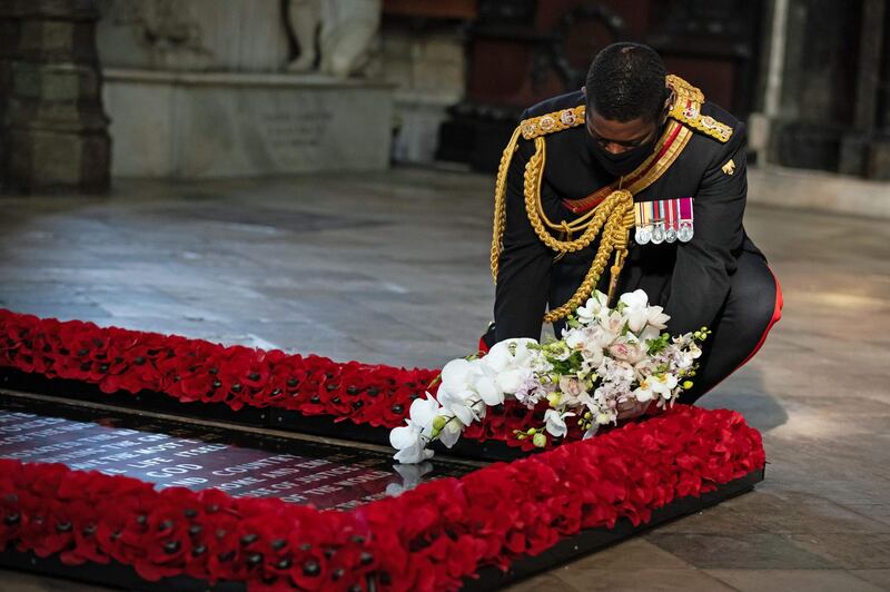 The Queen's Equerry, Lieutenant Colonel Nana Kofi Twumasi-Ankrah places a bouquet of flowers at the grave of the Unknown Warrior to mark the centenary of the burial of the Unknown Warrior ahead of Remembrance Sunday at Westminster Abbey in London on November 4, 2020.  In the small private ceremony, The Queen honoured the Unknown Warrior and the Royal Family’s own associations with the First World War and the grave at Westminster Abbey.
As part of the ceremony, a bouquet of flowers featuring orchids and myrtle - based on Her Majesty’s own wedding bouquet from 1947 - was placed on the grave of the Unknown Warrior in an act of remembrance. The gesture reflected the custom of Royal bridal bouquets being placed on the grave, a tradition which began in 1923 when Lady Elizabeth Bowes-Lyon, the future Queen Elizabeth The Queen Mother, laid her bouquet as she entered the Abbey in memory of her brother Fergus, who was killed at the Battle of Loos in 1915.
The grave of the Unknown Warrior is the final resting place of an unidentified British serviceman who died on the battlefields during the First World War. The serviceman’s body was brought from Northern France and buried at Westminster Abbey on 11th November 1920 after a procession through Whitehall.  / AFP / POOL / PA WIRE / Aaron Chown
