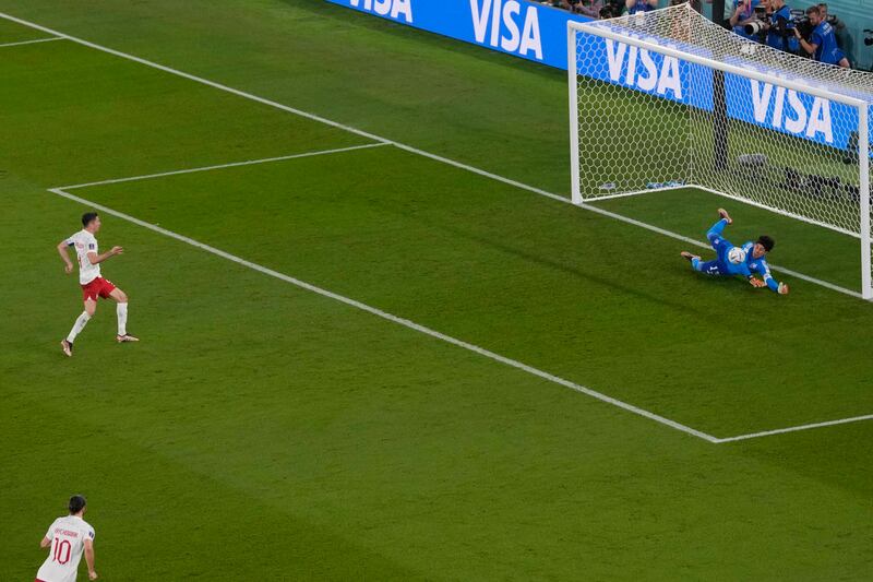 Mexico's goalkeeper Guillermo Ochoa saves on a penalty kick by Poland's Robert Lewandowski during the World Cup group C soccer match between Mexico and Poland, at the Stadium 974 in Doha, Qatar. AP Photo