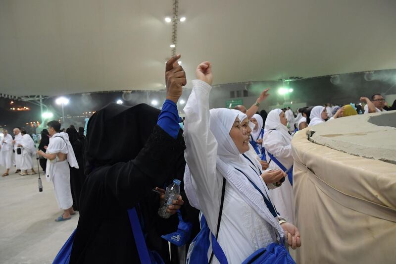 Muslim worshippers throw pebbles as part of the symbolic al-A'qabah (stoning of the devil ritual) at the Jamarat Bridge during the Hajj pilgrimage in Mina, near Makkah, Saudi Arabia.  AFP