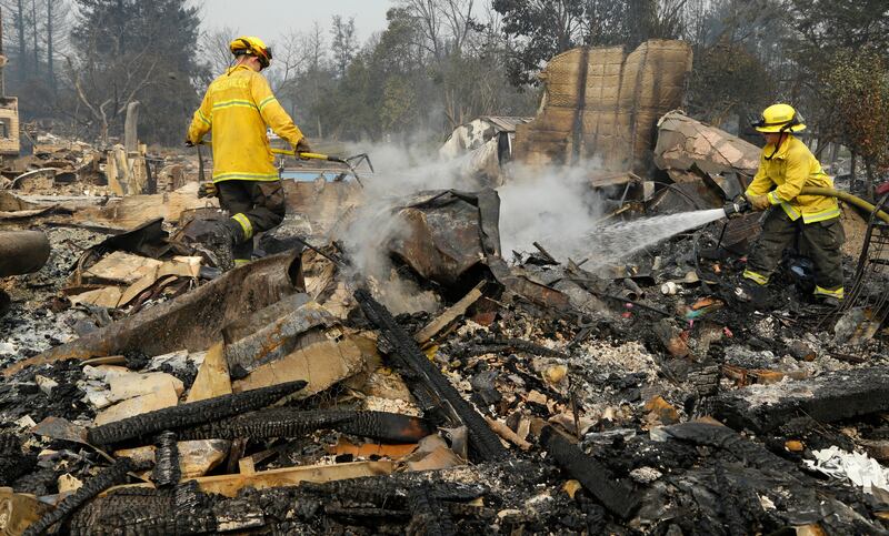 Firefighters douse hot spots in the Coffey Park area of Santa Rosa, California. Ben Margot / AP Photo