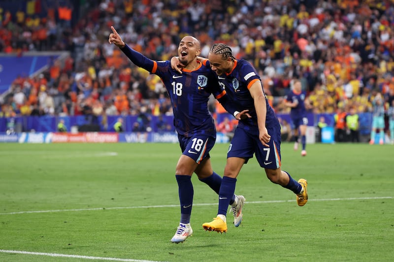 Donyell Malen of the Netherlands celebrates scoring his team's third goal with teammate Xavi Simons during their 3-0 Euro 2024 last-16 win over Romania at Munich Football Arena on July 2, 2024. Getty Images