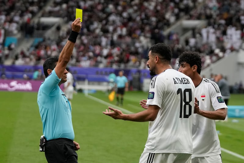 Iraq's Aymen Hussein is shown a second yellow card. AP 