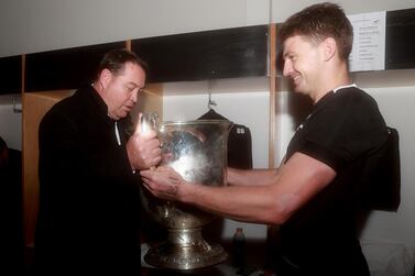 Beauden Barrett of the All Blacks and coach Steve Hansen celebrate with the Bledisloe Cup on Saturday. Hannah Peters / Getty Images