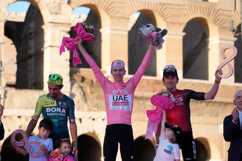 UAE Team Emirates rider Tadej Pogacar, centre, celebrates his overall victory in the Giro d'Italia with second-placed Daniel Martinez, left, and third-placed Geraint Thomas on the podium after the final stage in Rome on Sunday, May 26, 2024. AP 