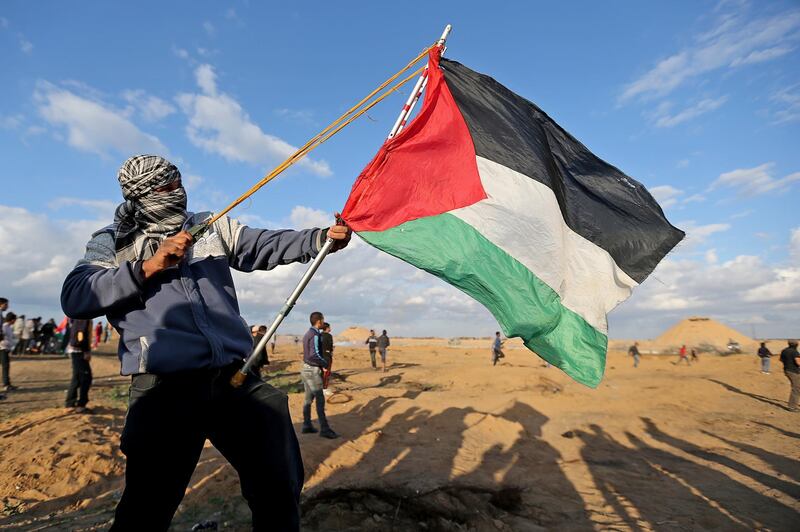 A Palestinian demonstrator uses a sling during an anti-Israel protest at the Israel-Gaza border fence, in the southern Gaza Strip December 6, 2019.  REUTERS/Ibraheem Abu Mustafa