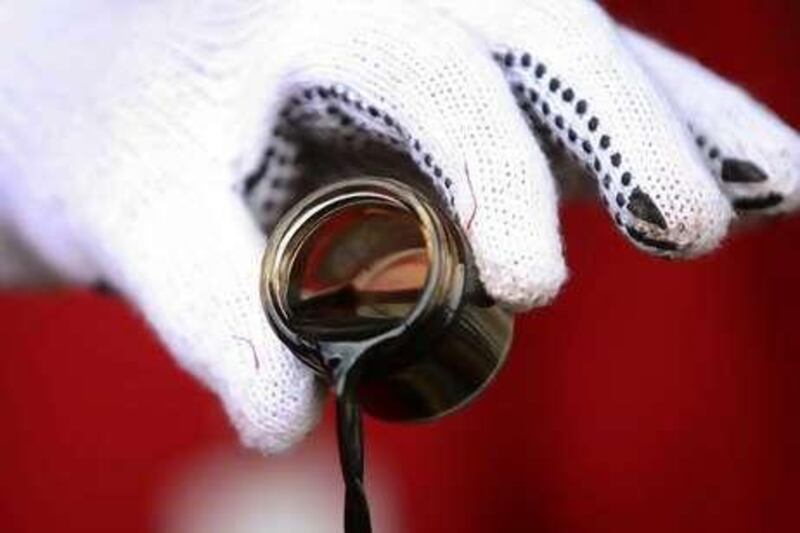 Oil's outpouring: Venezuela's president Hugo Chavez takes a sample of crude oil.