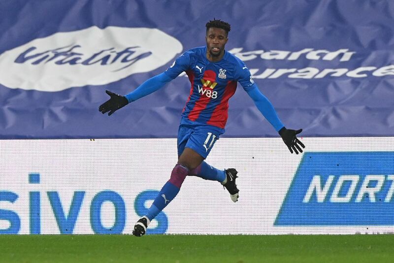 Crystal Palace's Ivorian striker Wilfried Zaha celebrates scoring the opening goal during the English Premier League football match between Crystal Palace and Leicester City at Selhurst Park in south London on December 28, 2020. RESTRICTED TO EDITORIAL USE. No use with unauthorized audio, video, data, fixture lists, club/league logos or 'live' services. Online in-match use limited to 120 images. An additional 40 images may be used in extra time. No video emulation. Social media in-match use limited to 120 images. An additional 40 images may be used in extra time. No use in betting publications, games or single club/league/player publications.
 / AFP / POOL / FACUNDO ARRIZABALAGA / RESTRICTED TO EDITORIAL USE. No use with unauthorized audio, video, data, fixture lists, club/league logos or 'live' services. Online in-match use limited to 120 images. An additional 40 images may be used in extra time. No video emulation. Social media in-match use limited to 120 images. An additional 40 images may be used in extra time. No use in betting publications, games or single club/league/player publications.
