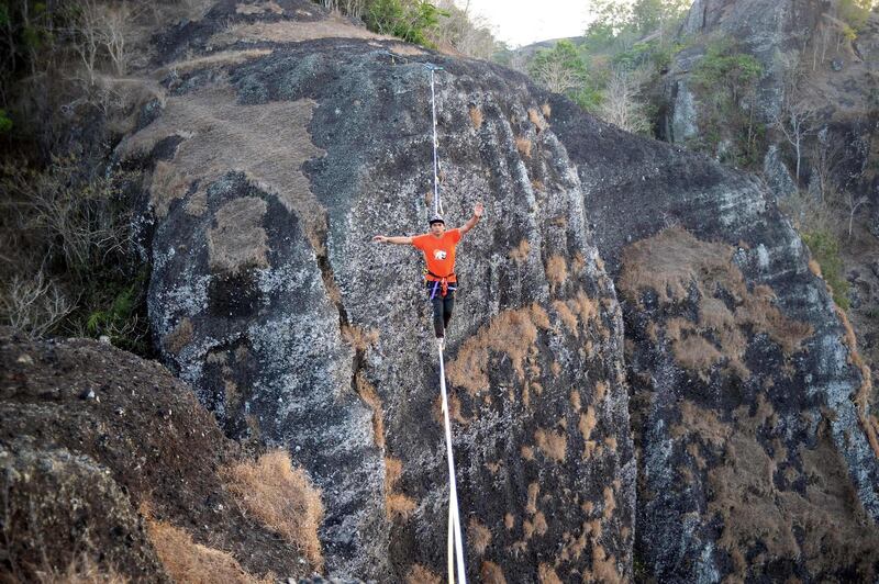 Extreme sport athlete Andi Ardi walks on a tightrope 740 metres in the air around Mount Nglanggeran in Yogyakarta, Indonesia. AFP