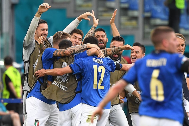 Italy midfielder Matteo Pessina is mobbed after scoring against Wales. AFP