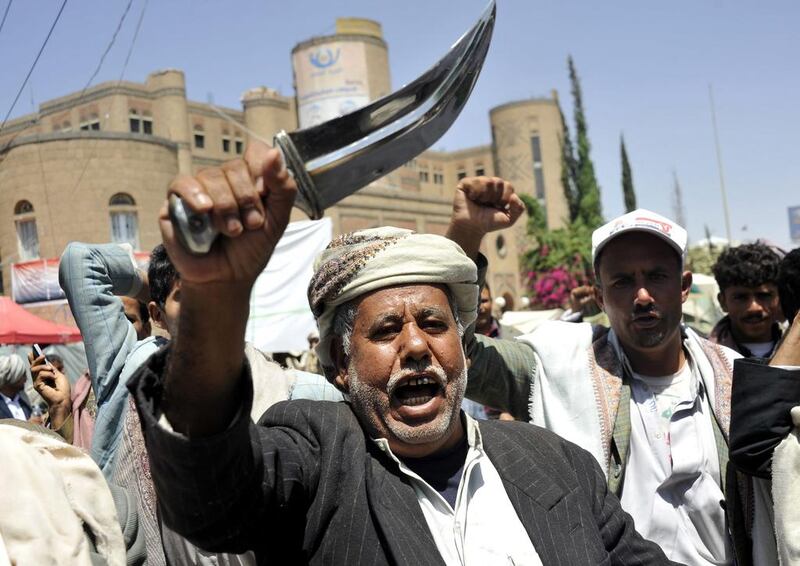 A Yemeni supporter of the Shiite Houthi movement shouts anti-government slogans and brandishes a traditional dagger at a sit-in camp in the capital Sanaa on Saturday. Yahya Arhab / EPA