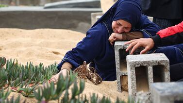 A woman cries over the grave of a loved one at a cemetery in Rafah, southern Gaza. AFP