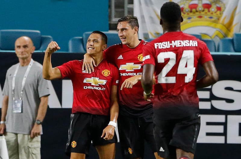 epa06921126 Manchester United forward Alexis Sanchez (L) celebrates his first half goal with teammates Matteo Darmian (C) and Timothy Fosu-Mensah as they played against Real Madrid in their International Champions Cup match at Hard Rock Stadium in Miami Gardens, Florida, USA, 31 July 2018. Manchester United won the match.  EPA/JOE SKIPPER