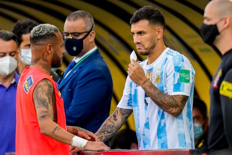 Argentina's Leandro Paredes, right, talks to Brazil's Neymar. AP