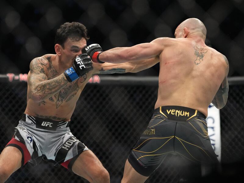 Alexander Volkanovski and Max Holloway trade shots during their bout at UFC 276. Reuters