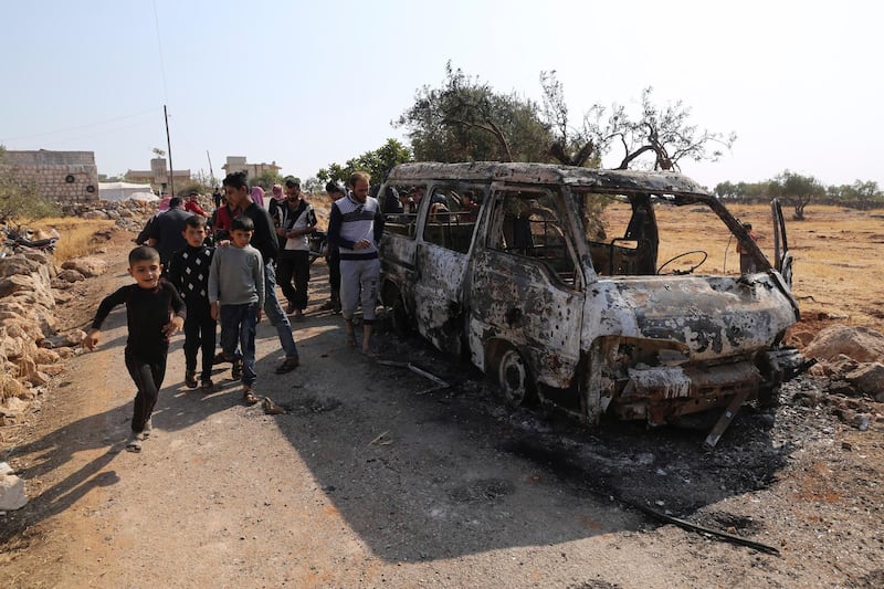People look at a destroyed van near the village of Barisha, in Idlib province, Syria, on Sunday, October 27, 2019, after an operation by the US military which targeted Abu Bakr Al Baghdad. AP Photo