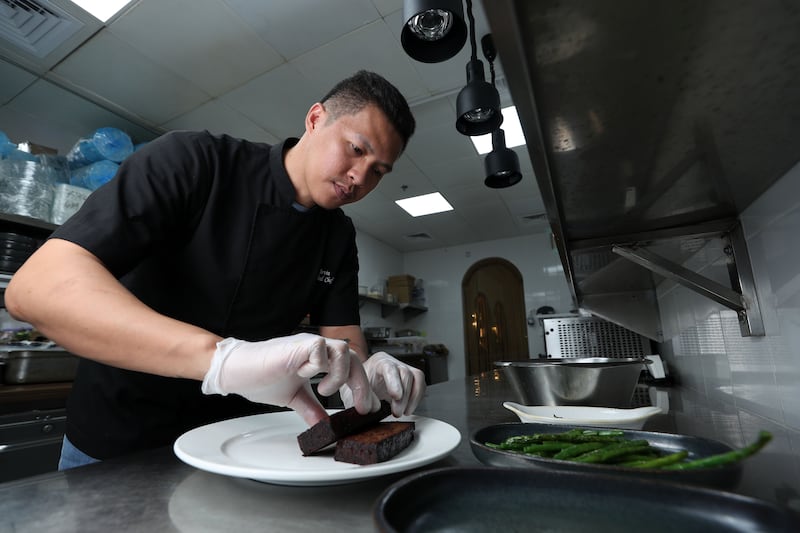 Head chef Alvin Valerio plates up the meatloaf at The Strand on Palm Jumeirah, Dubai