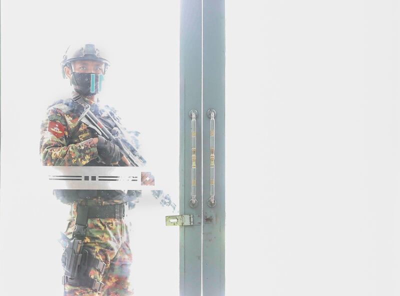A member of the Myanmar military special forces stands guard near a glass door during a donation ceremony by Myanmar military for the ongoing pandemic of the coronavirus disease in Yangon, Myanmar. EPA