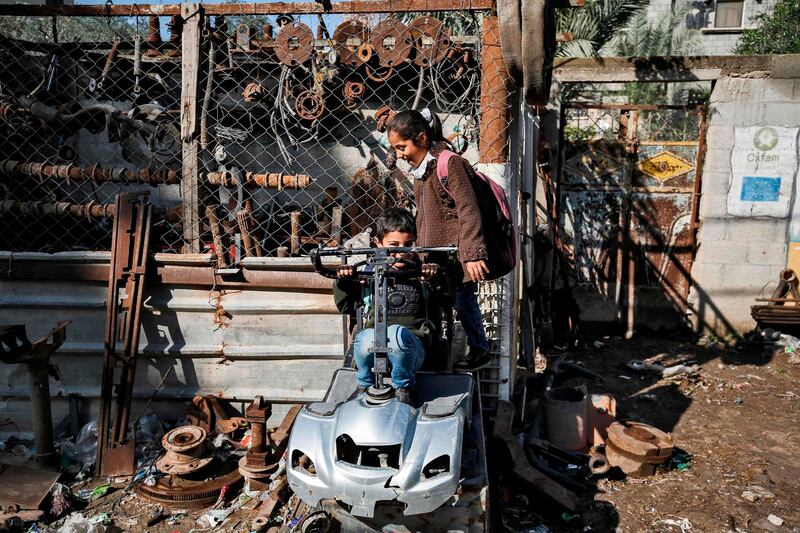 Palestinian children play at a scrapyard in Gaza City. AFP