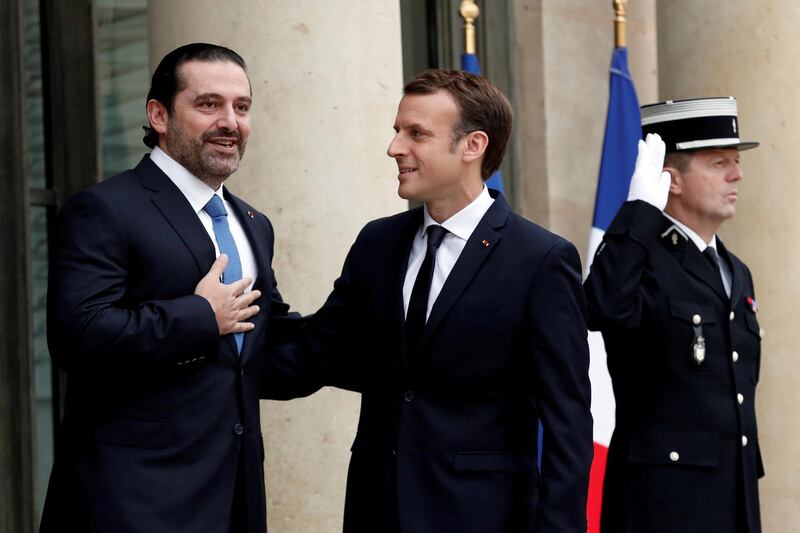 French President Emmanuel Macron and Saad al-Hariri, who announced his resignation as Lebanon's prime minister while on a visit to Saudi Arabia, react on the steps of the Elysee Palace in Paris, France, November 18, 2017. REUTERS/Benoit Tessier     TPX IMAGES OF THE DAY