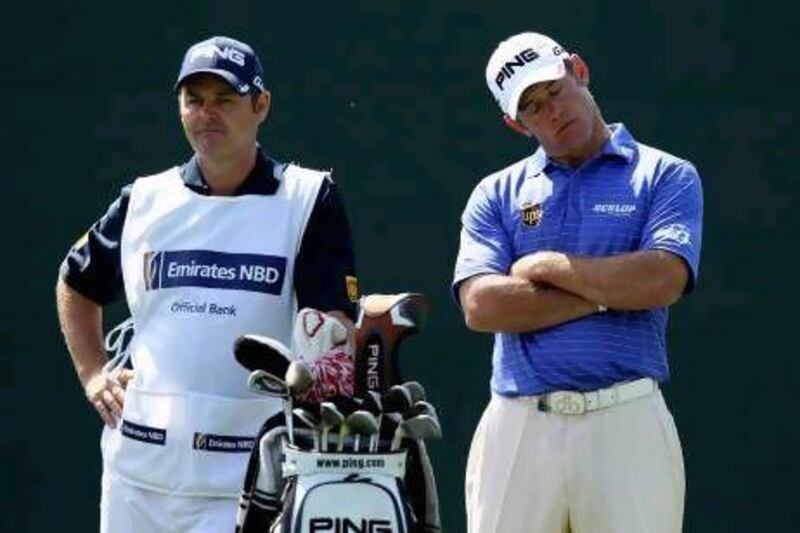 Lee Westwood of England stands with his caddie Billy Foster.