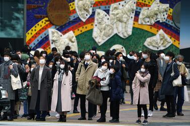 People wearing protective masks to help curb the spread of the coronavirus in the Shibuya area of Tokyo. AP